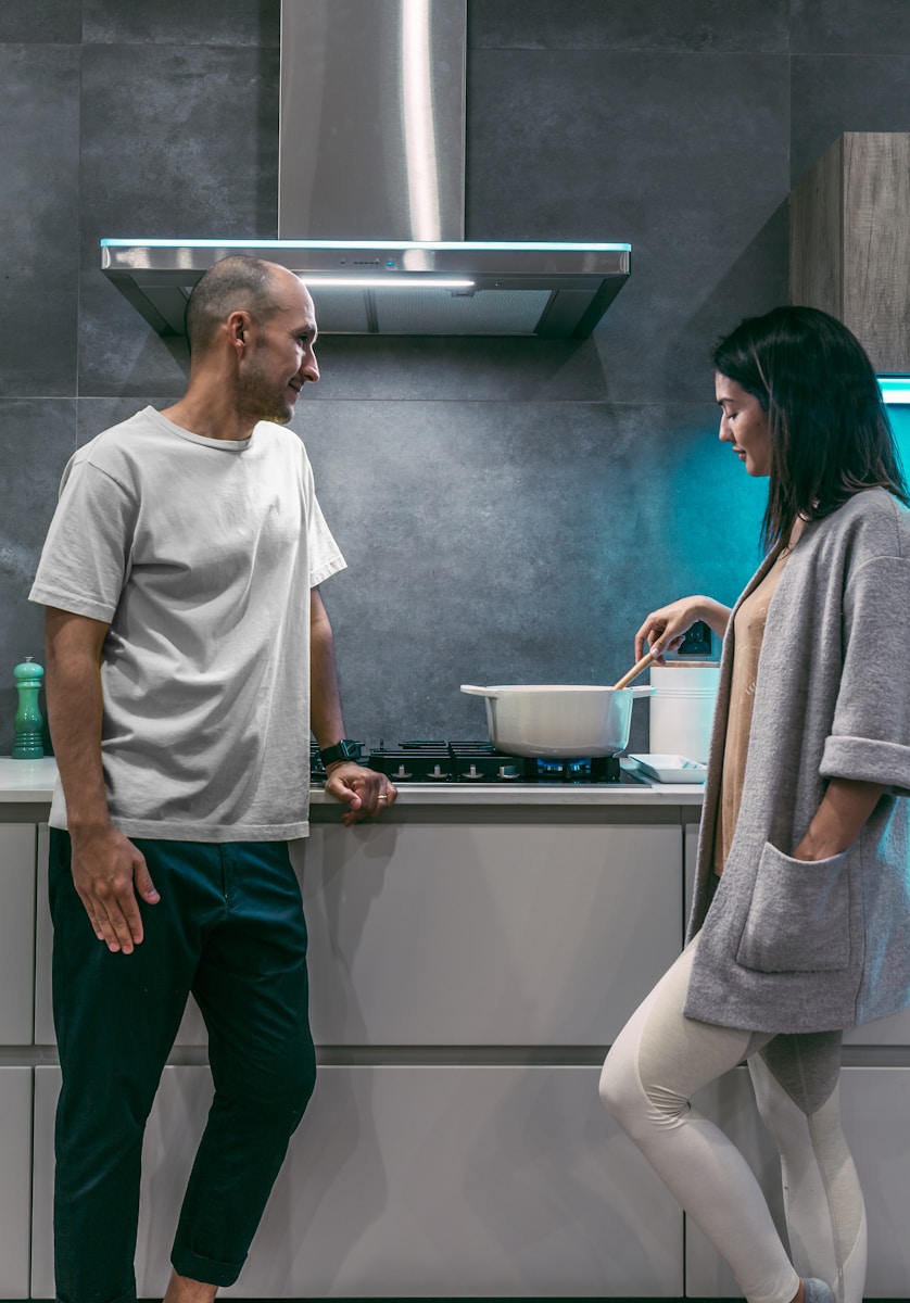 woman and man standing inside kitchen room discussing homeowners deductibles